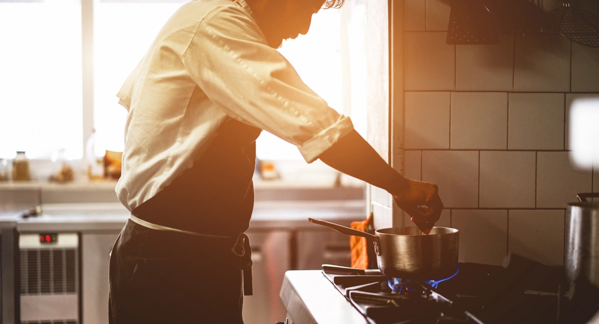 Male chef cooking in a restaurant kitchen