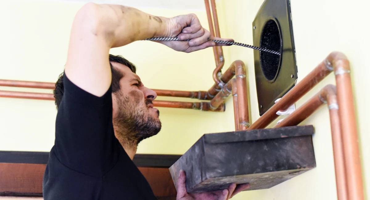 Man cleaning chimney