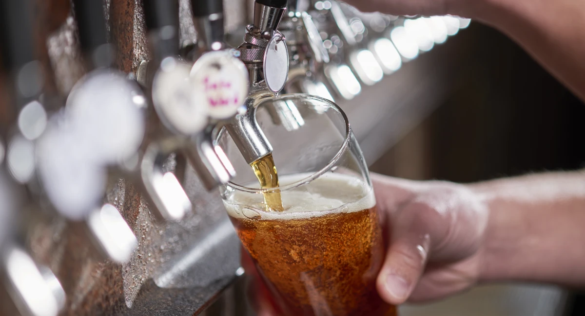 Pouring craft beer from a bar tap