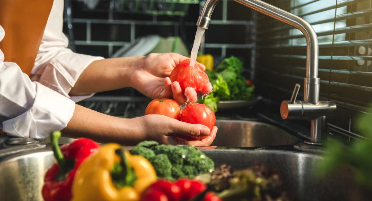 Person washing veggies
