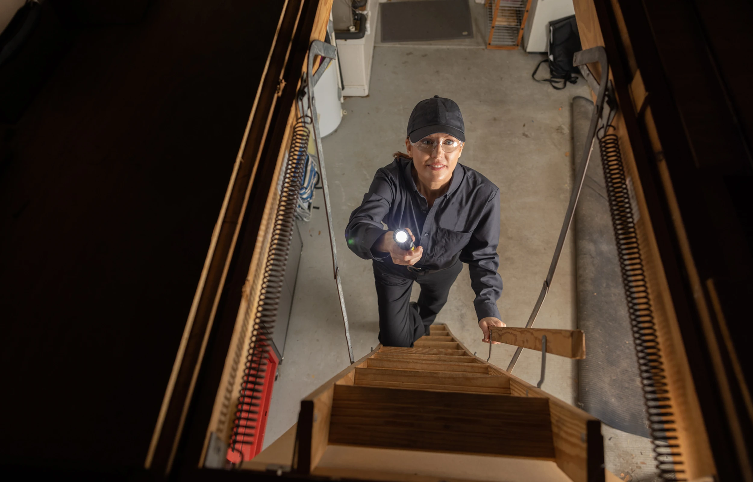 technician entering attic with lit torch