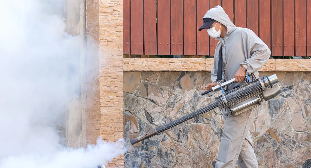 A technician fumigating a property