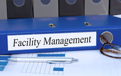 A binder labeled "Facility Management".
