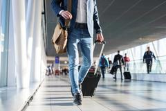 People walking through an airport.