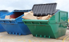 Dumpsters in a parking lot.