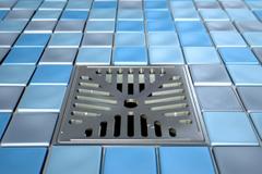 A drain on a tiled floor.