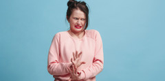 A woman making a disgusted face.