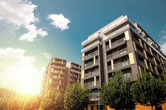An apartment complex surrounded by trees.