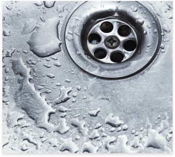 A closeup of water going down a drain.