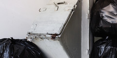 A trash chute filled with trash bags.