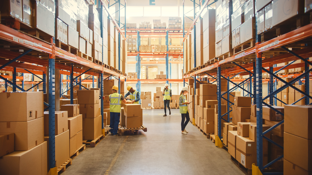 Employees manage inventory at a large warehouse.