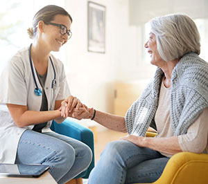 Health care worker comforting woman